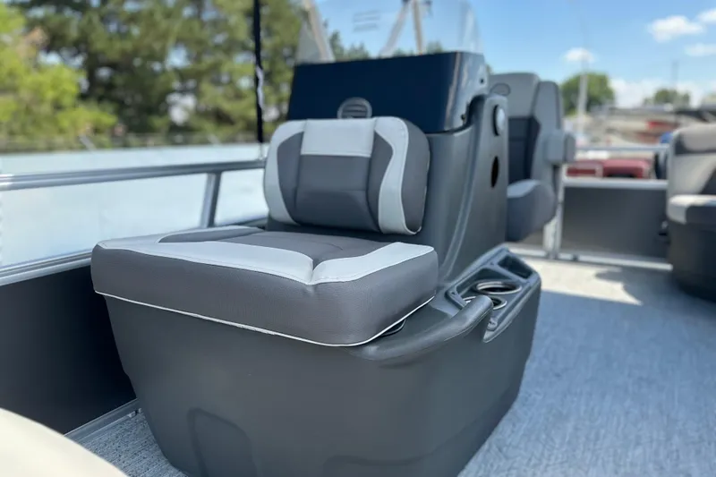 Slide: The Image of 2026 Sun Tracker Bass Buggy 16 DLX boat interior with cushioned seating and cup holders. - 10