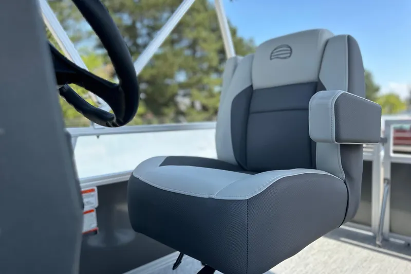 Slide: The Image of 2026 Sun Tracker Bass Buggy 16 DLX boat seat with steering wheel, outdoor setting. - 12