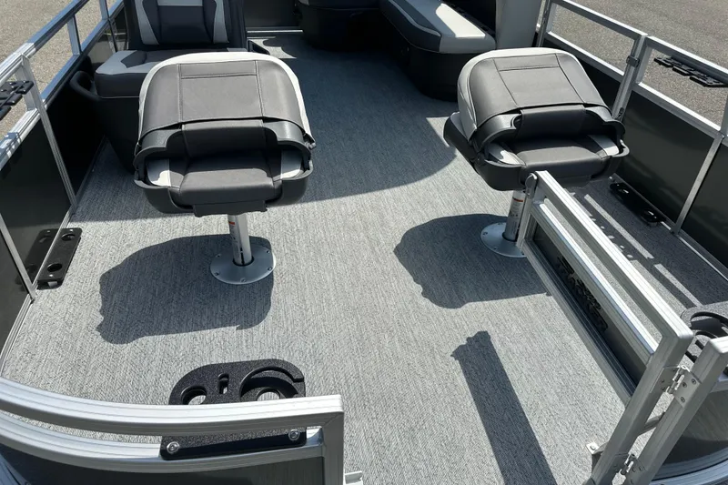 Slide: The Image of 2026 Sun Tracker Bass Buggy 16 DLX pontoon boat interior with seating and carpeted floor. - 6
