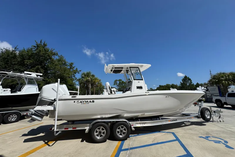 Slide: The Image of 2026 Caymas 291 boat on trailer under clear blue sky. - 10