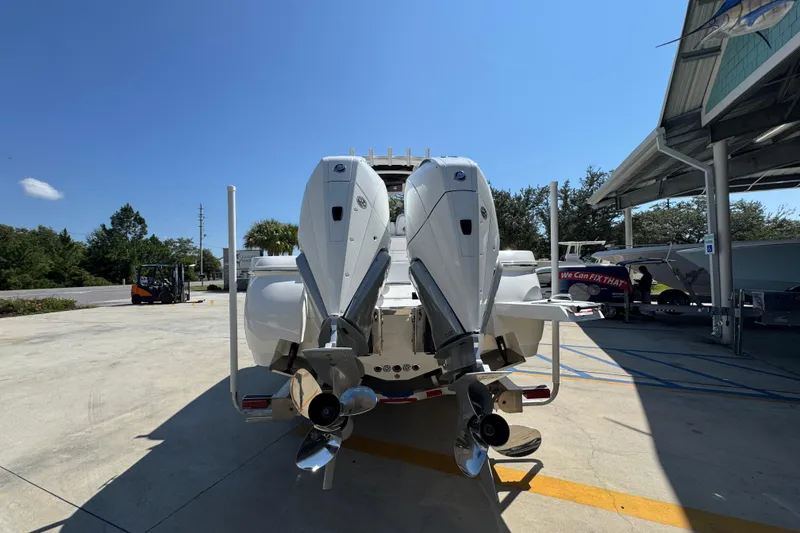 Slide: The Image of 2026 Caymas 291 boat with dual outboard motors in a sunny outdoor setting. - 13