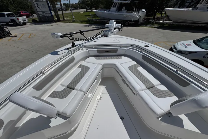 Slide: The Image of 2026 Caymas 291 boat interior with cushioned seating and modern design in a marina setting. - 18