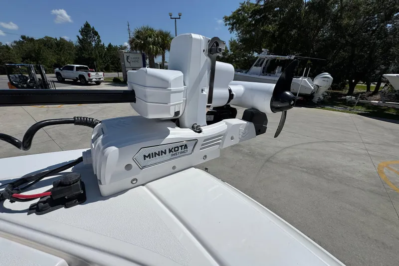 Slide: The Image of Minn Kota Instinct motor on 2026 Caymas 291 boat, parked outdoors under clear sky. - 20