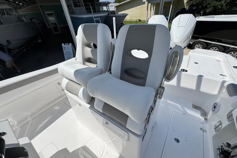 Slide: The Image of 2026 Caymas 291 boat with dual white and gray cushioned seats. - 27