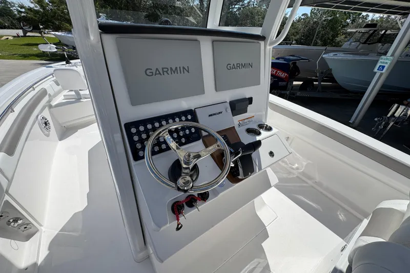 Slide: The Image of 2026 Caymas 291 boat console with Garmin displays and steering wheel. - 29