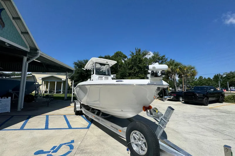 Slide: The Image of 2026 Caymas 291 boat on trailer in sunny outdoor setting. - 7
