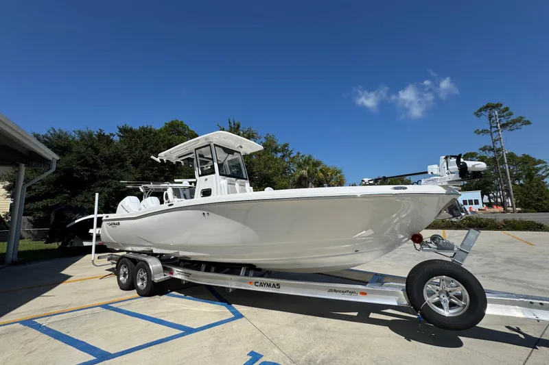 Slide: The Image of 2026 Caymas 291 boat on trailer under clear blue sky. - 8