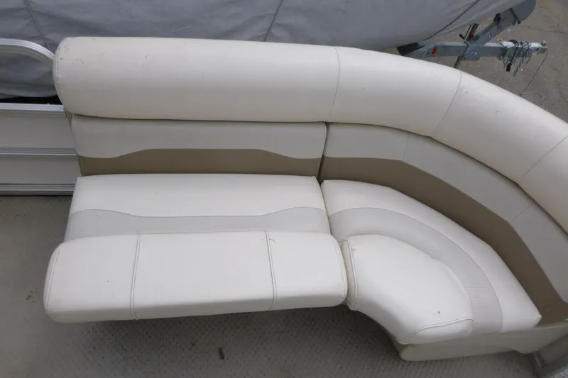 Slide: The Image of 2007 SunChaser 8520 Cruise boat seating, featuring white and beige cushioned upholstery. - 10