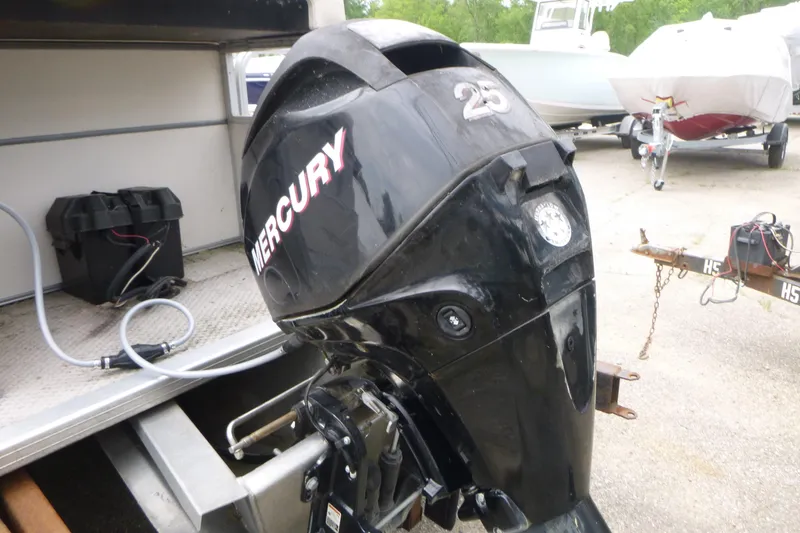 Slide: The Image of Outboard motor on a 2007 SunChaser 8520 Cruise boat, parked with other boats. - 13