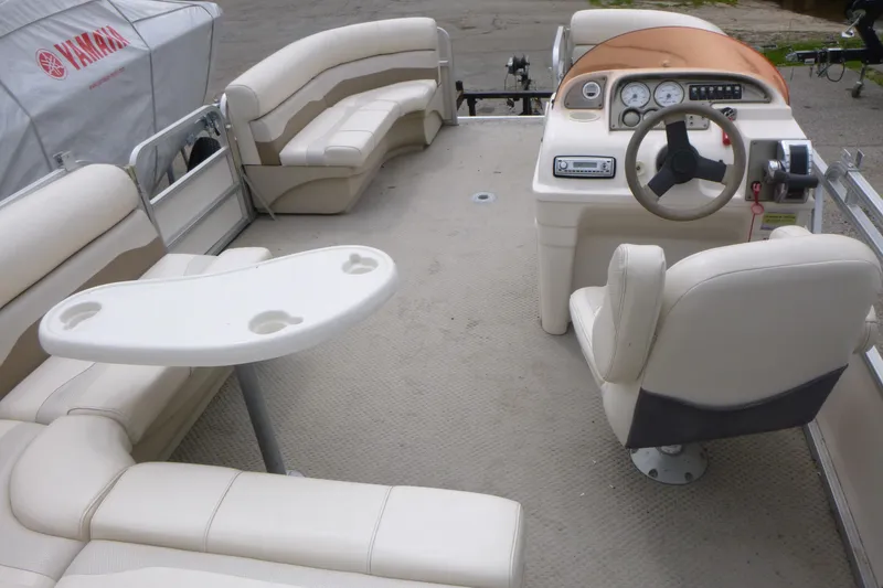 Slide: The Image of 2007 SunChaser 8520 Cruise pontoon boat interior with seating and steering console. - 6