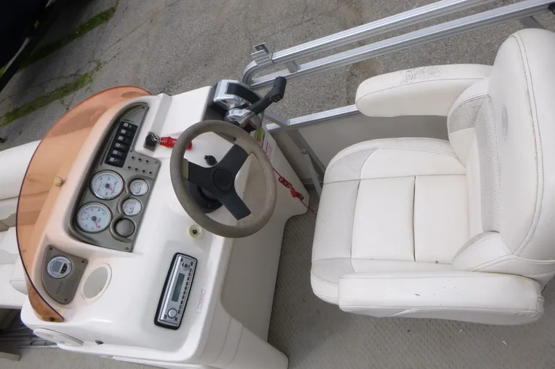 Slide: The Image of 2007 SunChaser 8520 Cruise boat dashboard with steering wheel and white captain's chair. - 7