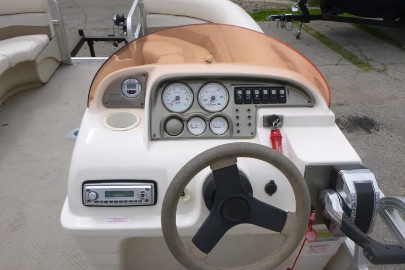 Slide: The Image of 2007 SunChaser 8520 Cruise boat dashboard with steering wheel and control panel. - 8