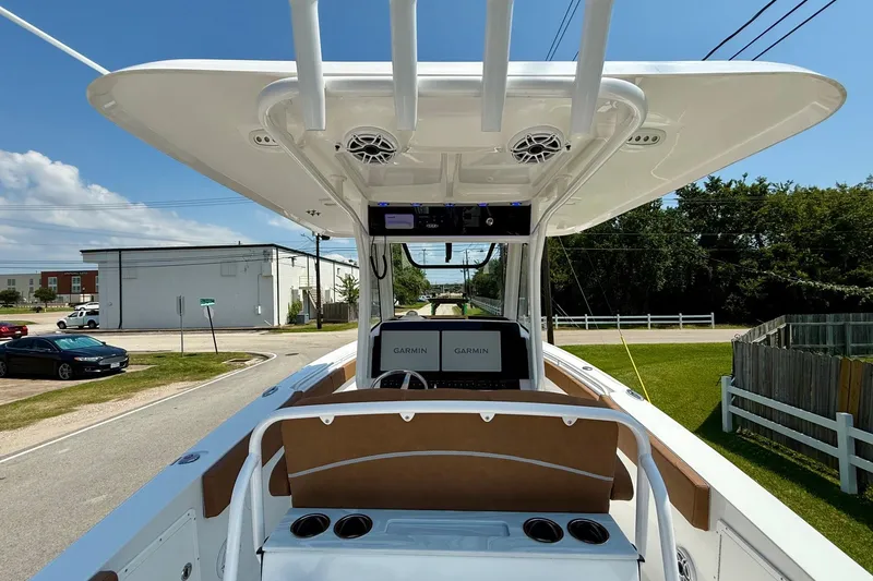 Slide: The Image of 2026 Sea Hunt Ultra 305 SE boat with Garmin navigation system, docked on a sunny day. - 11