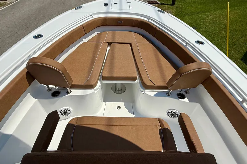 Slide: The Image of 2026 Sea Hunt Ultra 305 SE boat interior with brown cushioned seating. - 14