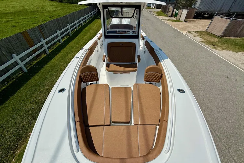 Slide: The Image of 2026 Sea Hunt Ultra 305 SE boat with tan seating and spacious deck. - 16