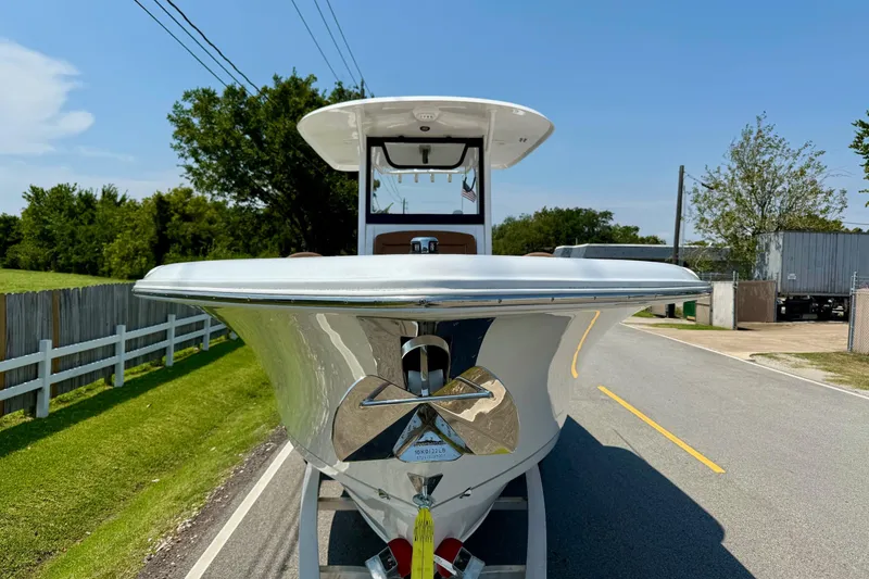 Slide: The Image of 2026 Sea Hunt Ultra 305 SE boat on a road, front view, sunny day. - 6