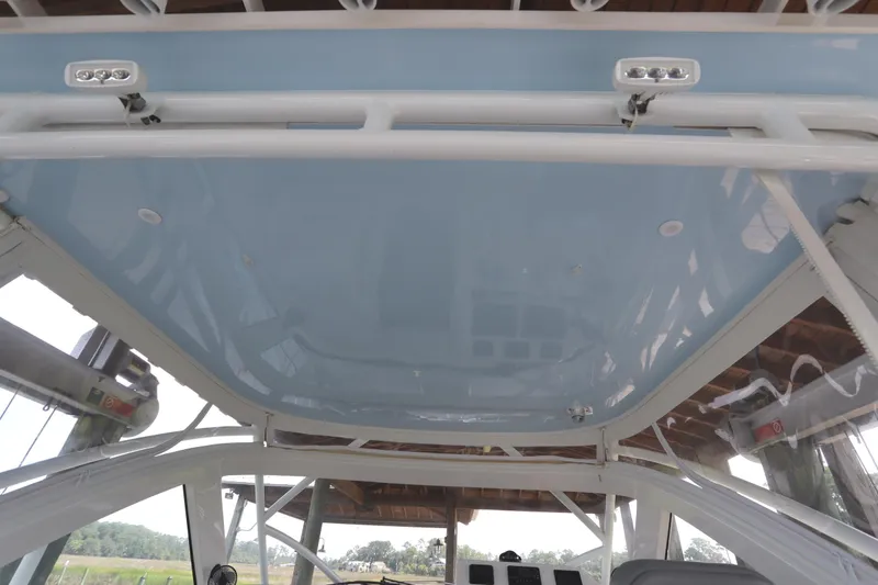 Slide: The Image of 2024 Albemarle 30 Express boat under a wooden shelter, showcasing sleek design and structure. - 10