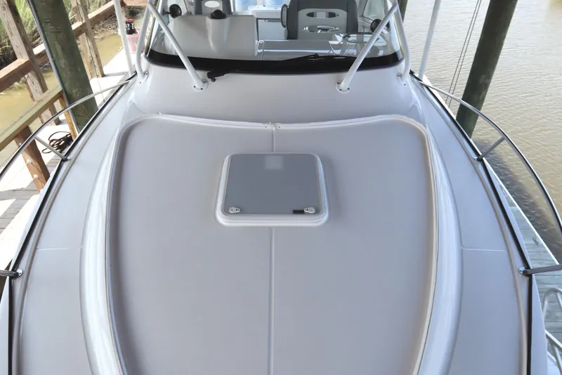 Slide: The Image of 2024 Albemarle 30 Express boat under a wooden canopy, featuring Garmin equipment. - 13