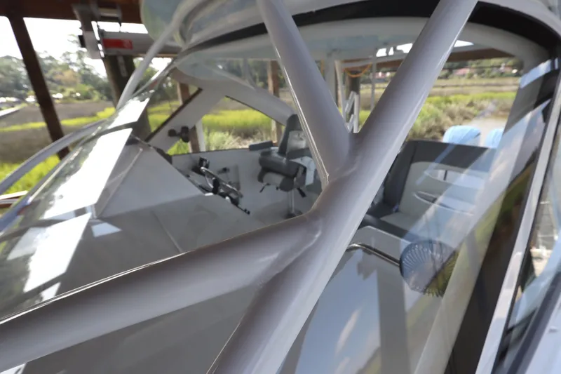 Slide: The Image of 2024 Albemarle 30 Express boat deck with hatch, docked by wooden posts. - 14