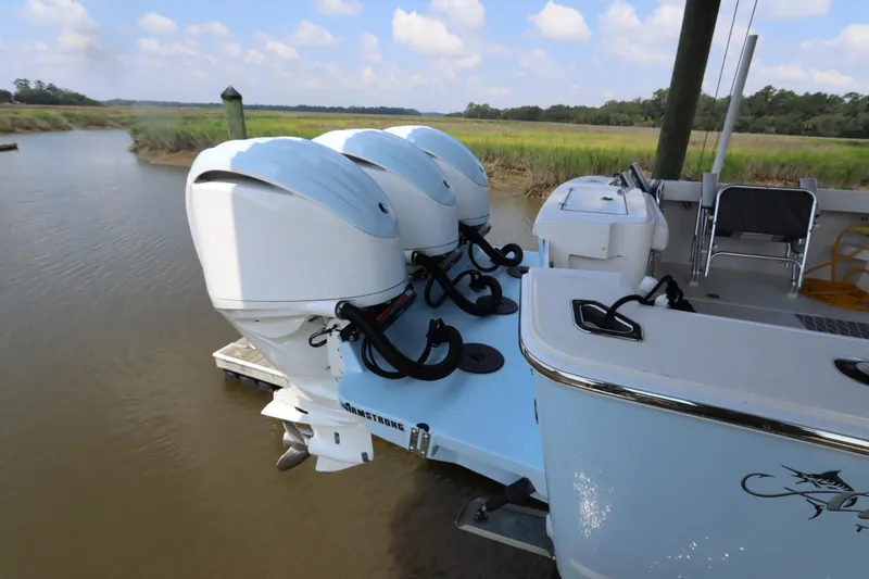 Slide: The Image of 2024 Albemarle 30 Express boat deck with Yamaha engines and storage compartment. - 25