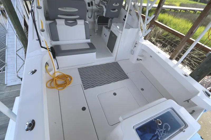 Slide: The Image of Open storage compartment on 2024 Albemarle 30 Express boat with yellow cable nearby. - 33