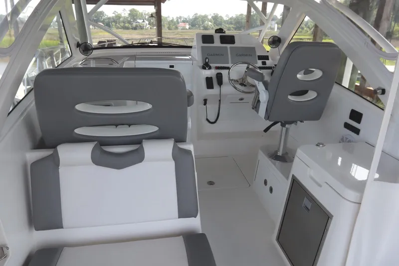 Slide: The Image of 2024 Albemarle 30 Express boat interior seating with cup holders and storage. - 38
