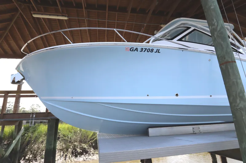 Slide: The Image of 2024 Albemarle 30 Express boat docked near a wooden pier. - 4