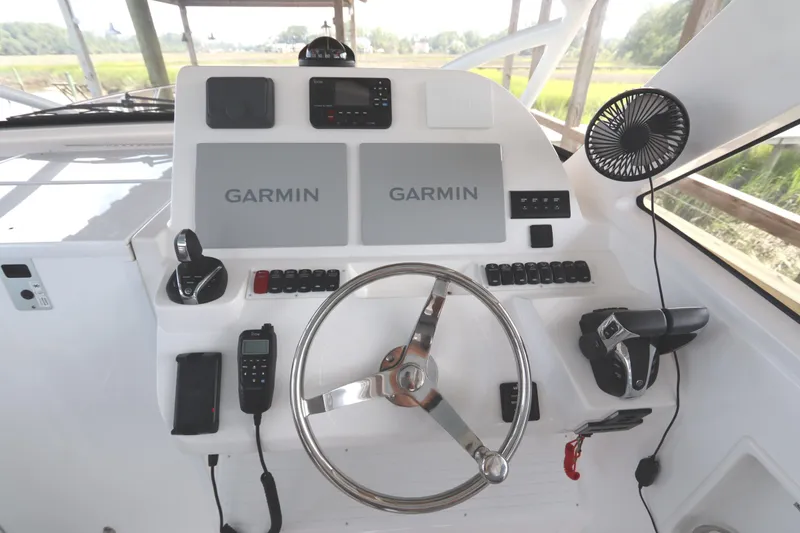 Slide: The Image of 2024 Albemarle 30 Express boat compartment with secured metal rod. - 44