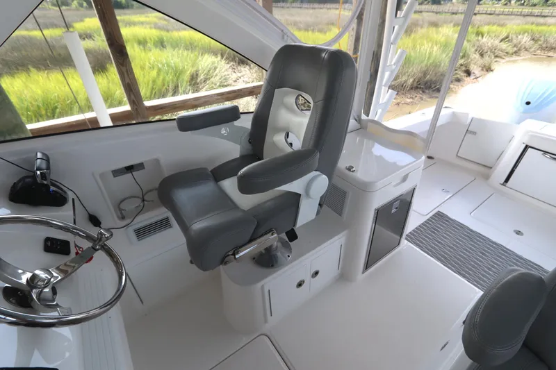 Slide: The Image of 2024 Albemarle 30 Express boat interior with captain's chair and helm station. - 46