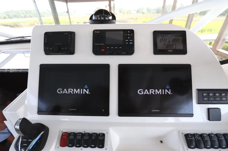 Slide: The Image of 2024 Albemarle 30 Express boat interior with helm seat and steering wheel. - 47