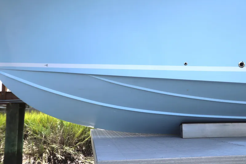 Slide: The Image of 2024 Albemarle 30 Express boat in dry dock, light blue hull, side view. - 5