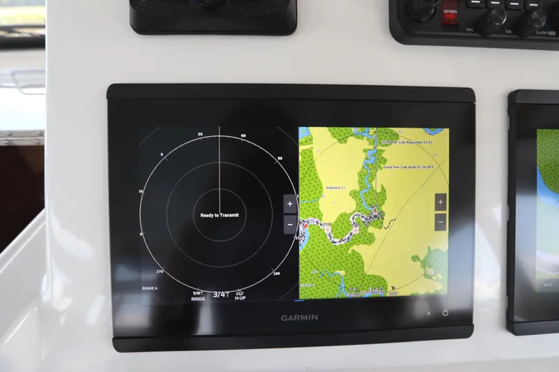 Slide: The Image of 2024 Albemarle 30 Express dashboard with Icom CommandMic and wireless charging pad. - 52