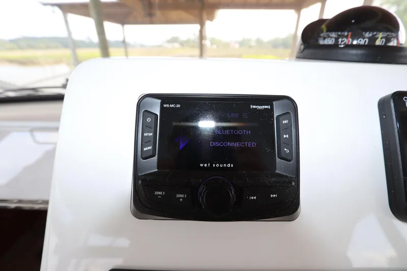Slide: The Image of 2024 Albemarle 30 Express boat controls with steering wheel and throttle levers. - 55