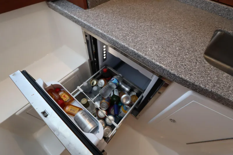 Slide: The Image of 2024 Albemarle 30 Express boat interior with stainless steel fridge and sink. - 64