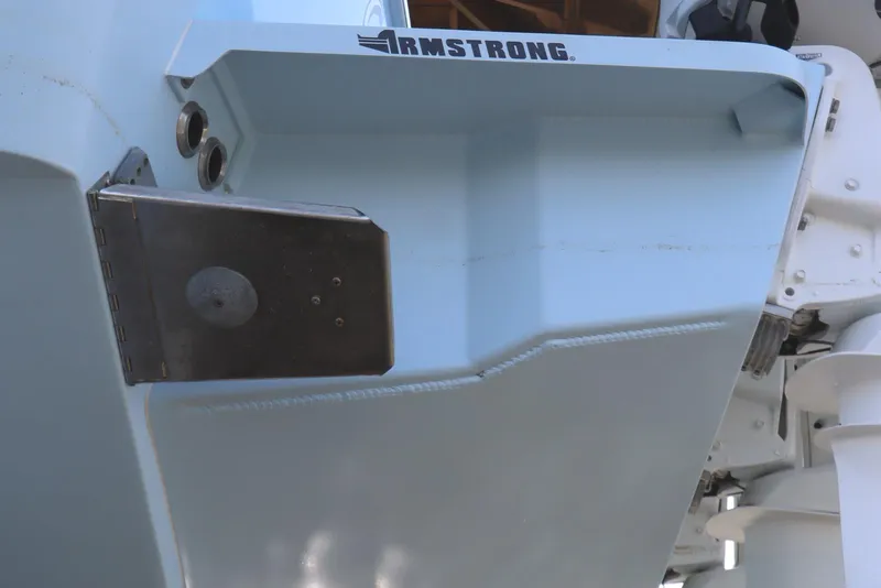 Slide: The Image of 2024 Albemarle 30 Express boat bow with anchor, docked under wooden shelter. - 7