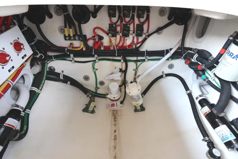 Slide: The Image of 2024 Albemarle 30 Express engine compartment with wiring and plumbing systems. - 83