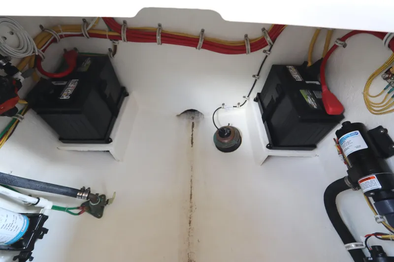 Slide: The Image of Engine compartment of 2024 Albemarle 30 Express, featuring filters, battery, and wiring. - 85