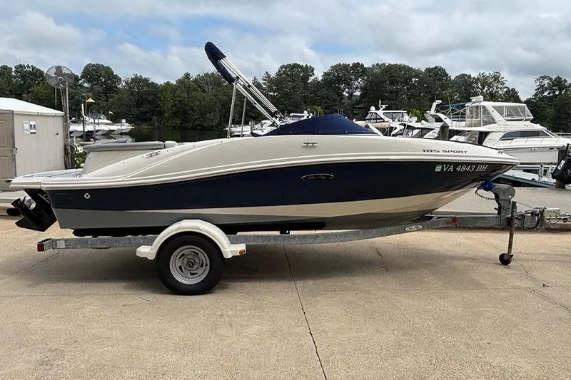 The Image of 2008 Sea Ray 185 Sport boat on trailer, dockside with other boats in background. - 1