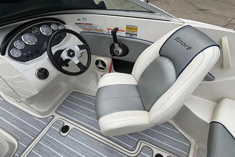 Slide: The Image of 2008 Sea Ray 185 Sport boat interior with steering wheel and cushioned seat. - 14