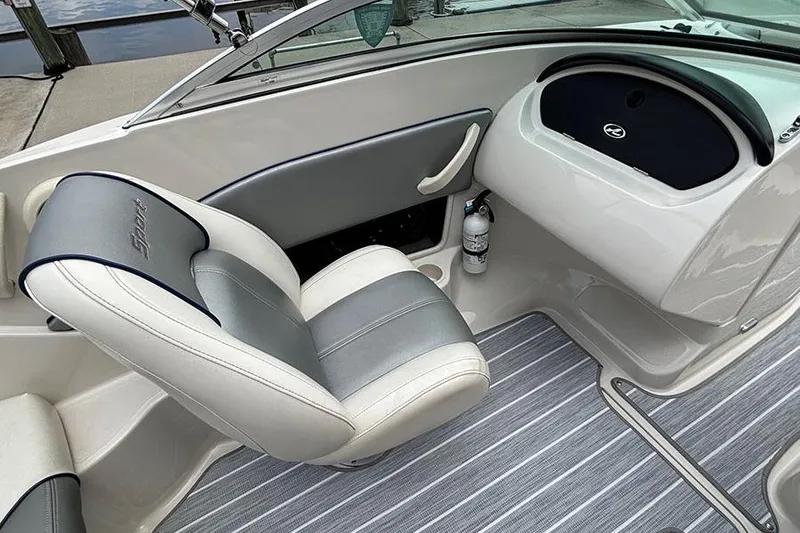 Slide: The Image of 2008 Sea Ray 185 Sport boat interior with gray and white seating, striped flooring. - 15