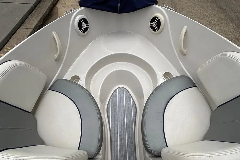 Slide: The Image of 2008 Sea Ray 185 Sport boat interior with cushioned seating and speakers. - 16