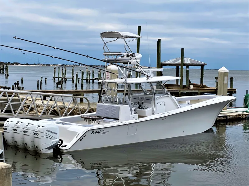 The Image of 2020 Front Runner 39 Center Console boat docked with triple outboard engines. - 0