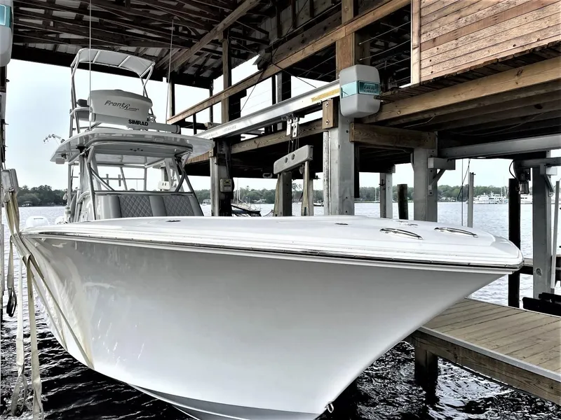 Slide: The Image of 2020 Front Runner 39 Center Console boat docked under a wooden shelter. - 10