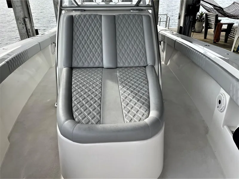 Slide: The Image of 2020 Front Runner 39 Center Console boat with diamond-stitched seating, docked by the water. - 16