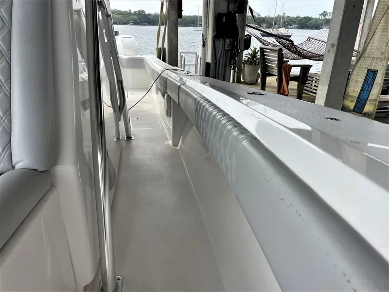 Slide: The Image of 2020 Front Runner 39 Center Console boat docked, showcasing sleek white interior and waterfront view. - 22