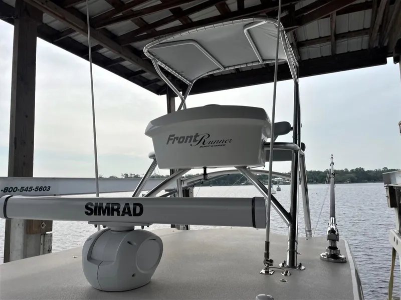 Slide: The Image of 2020 Front Runner 39 Center Console boat docked, featuring Simrad radar equipment. - 23