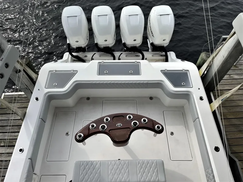 Slide: The Image of 2020 Front Runner 39 Center Console boat with four engines, docked by the water. - 27