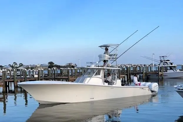 Slide: The Image of 2020 Front Runner 39 Center Console boat docked in calm waters. - 3