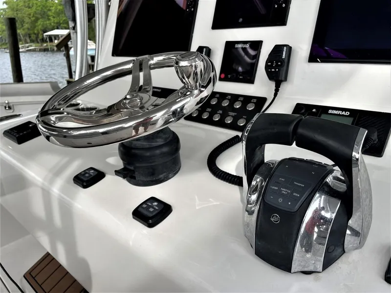 Slide: The Image of 2020 Front Runner 39 Center Console helm with steering wheel and controls. - 32