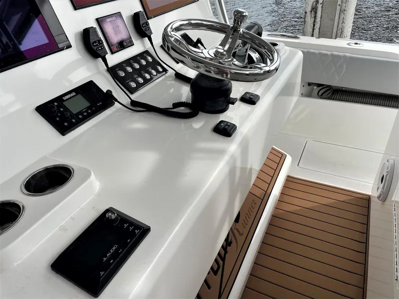Slide: The Image of 2020 Front Runner 39 Center Console helm with modern controls and teak flooring. - 33
